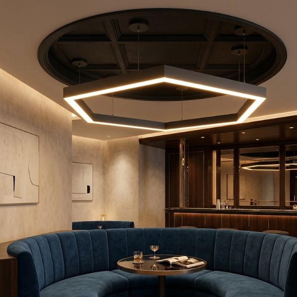 Elegant hexagon-shaped architectural linear light installed in a luxury hotel lounge, creating a warm, sophisticated atmosphere for a professional networking and dining area.